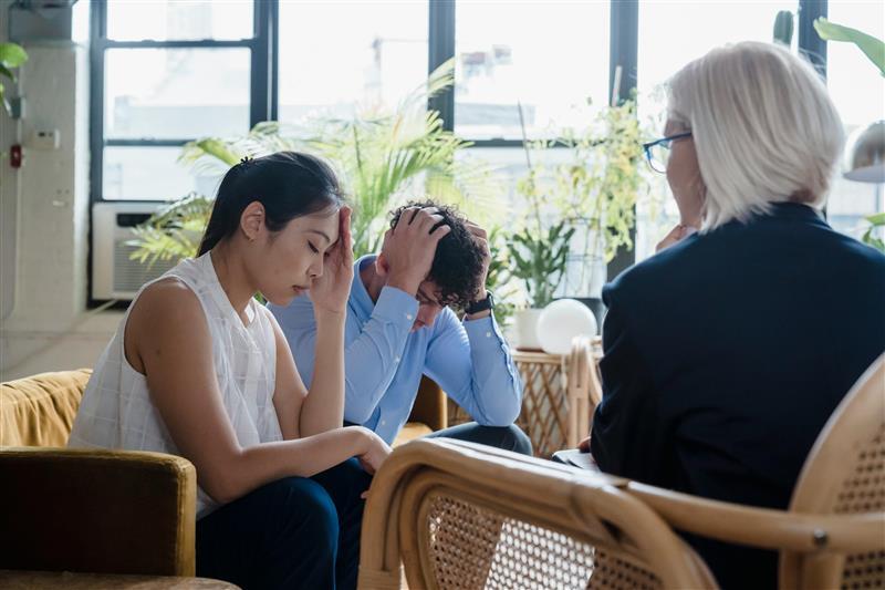 A professional listening to a couple during a supportive consultation